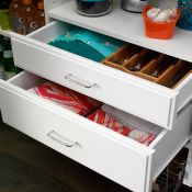 Need additional storage? Deluxe drawers keep linens, party supplies, or silverware at the ready but neatly out of sight. Use the standard White handles or dress it up as shown here with Chrome handles, sold separately.